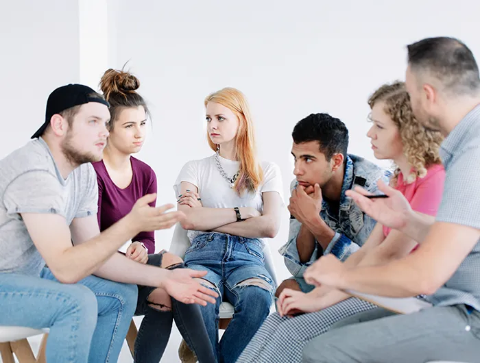 Community-crisis-stabilization-01 Group therapy session with participants discussing and listening