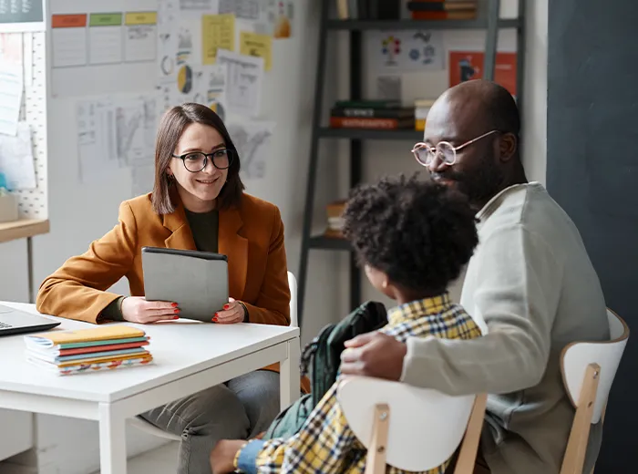 Teacher having meeting with parent of schoolboy